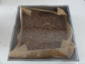 Nanaimo bar base wrapped in plastic